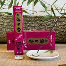 Nippon Kodo Rose Incense Sticks burning, with delicate smoke rising.