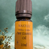 NAIOULI essential oil with some herbs and steam in the background.